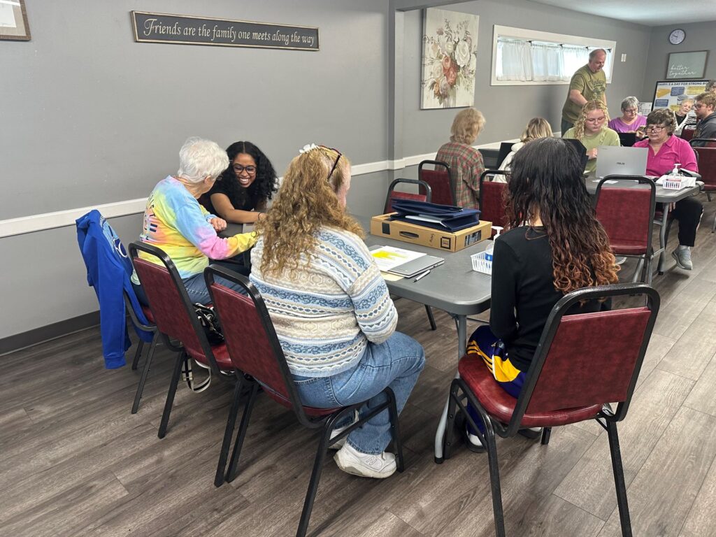 students and older adults looking at technology